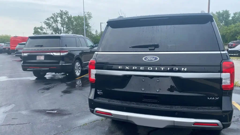 Two Black SUVs on road