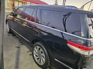 Sleek Lincoln Navigator with a bold grille, shining chrome accents, and elegant modern design