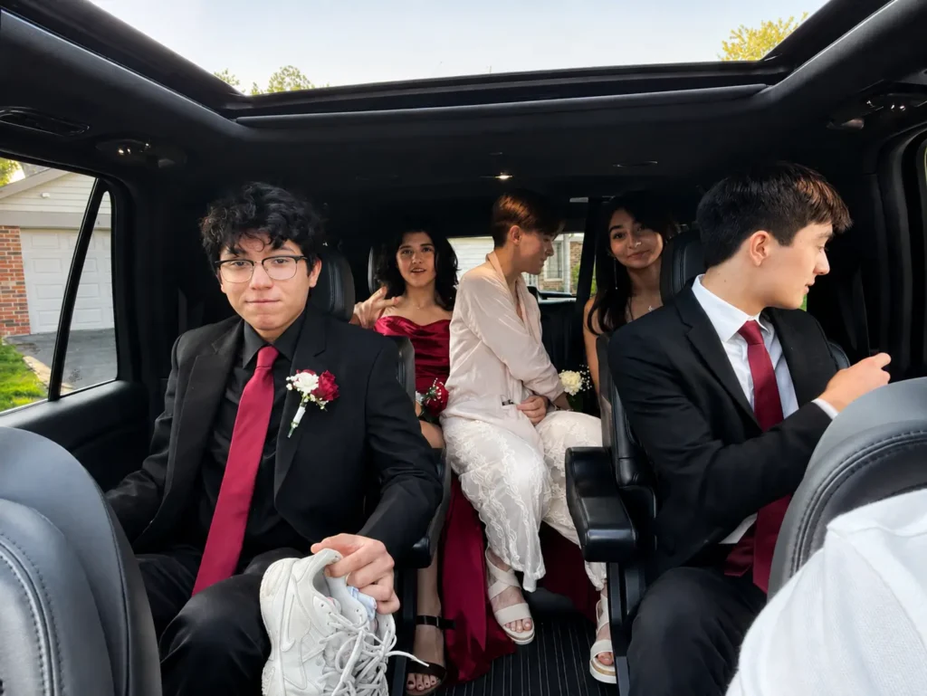 Prom group riding in a luxury chauffeur-driven SUV.