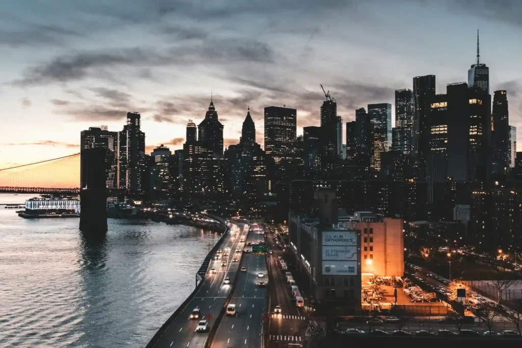 city-buildings-near-body-of-water-during-night-time-in-manhattan
